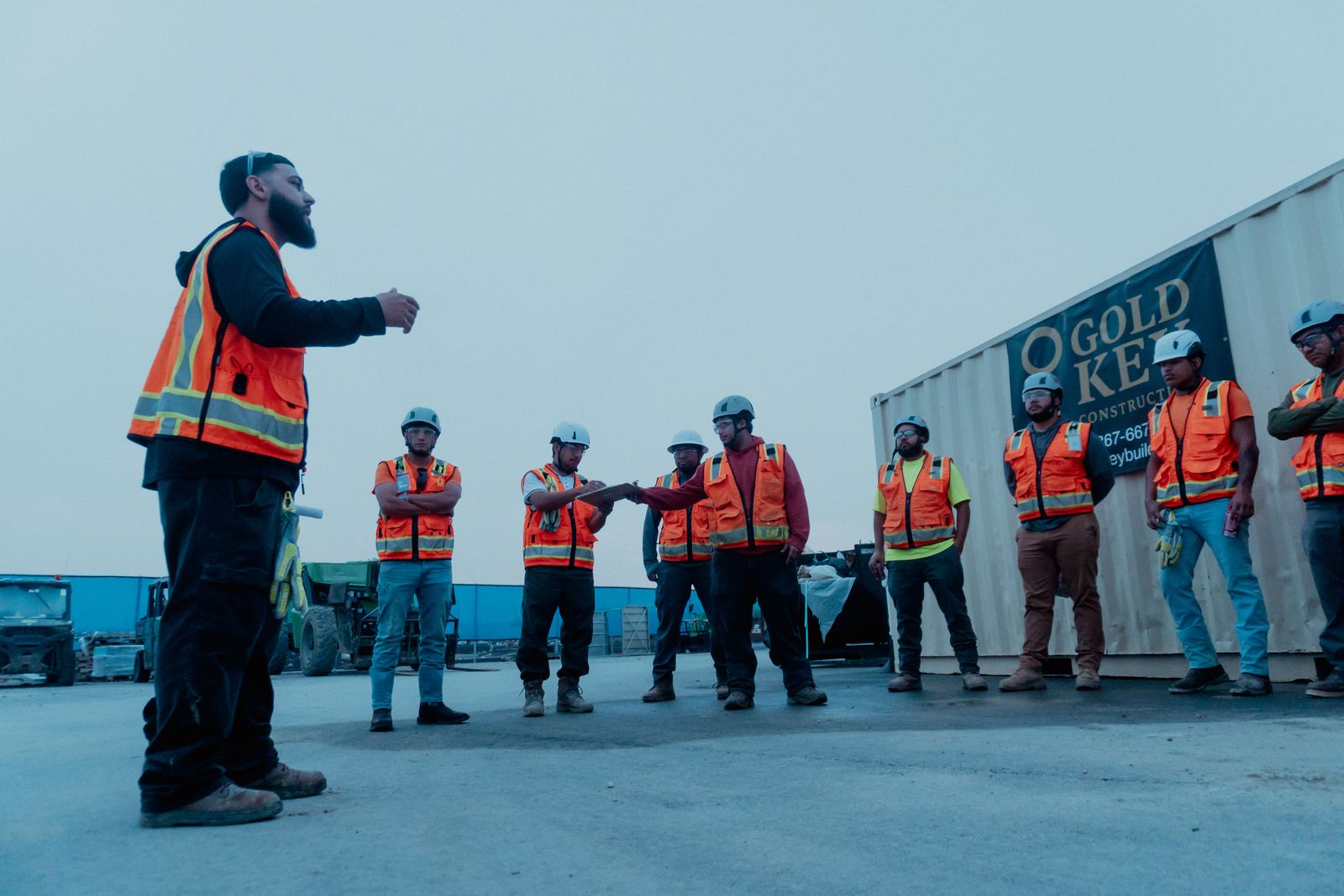 Gold Key foreman leading the crew huddle at the connex