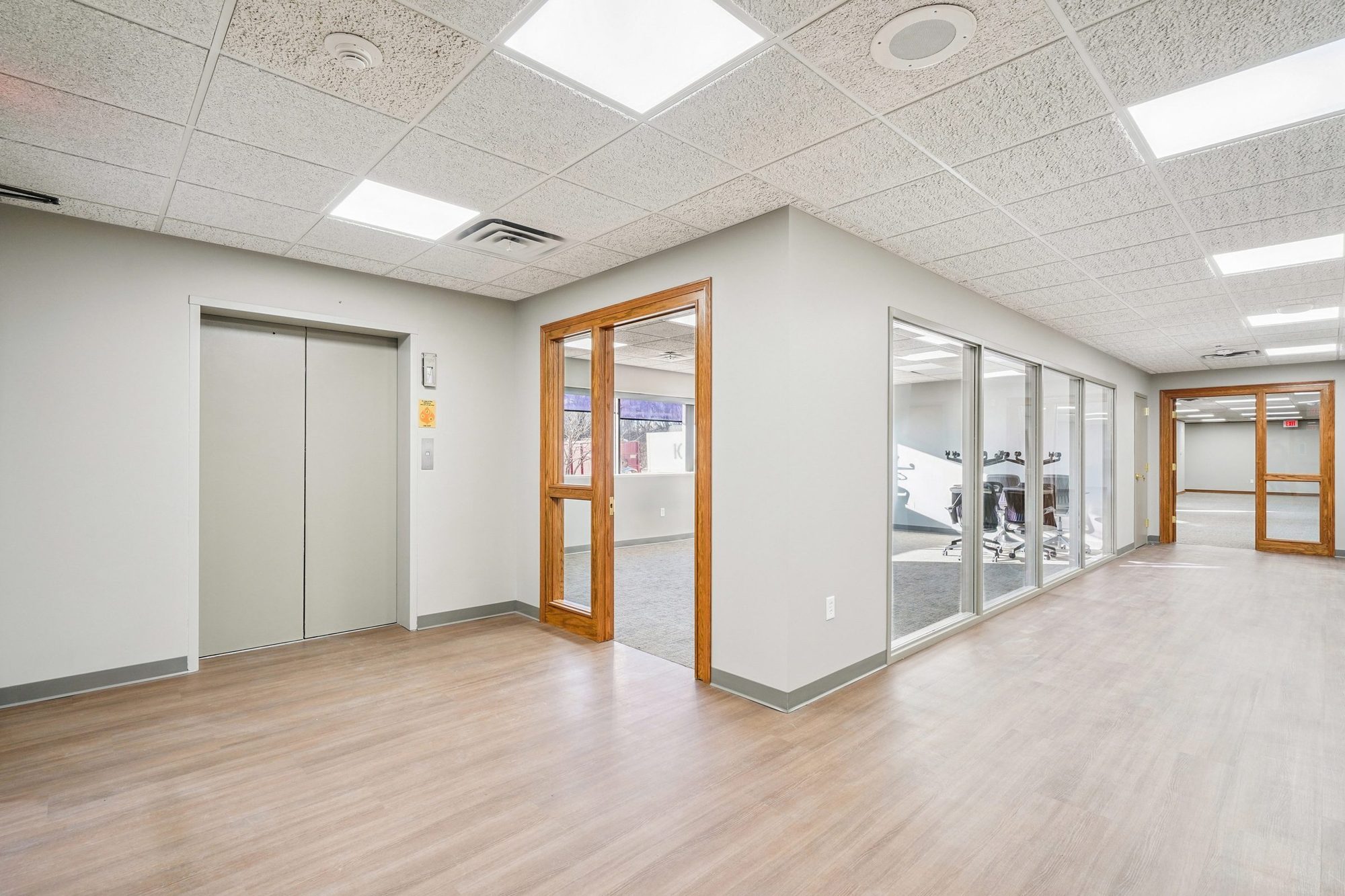 Office Building Remodel — elevator and glass-walled conference room