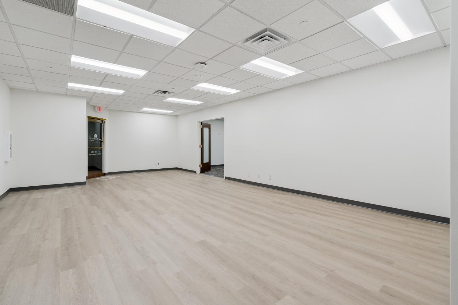 5,000 SF Office Renovation — open bullpen with new LVP flooring